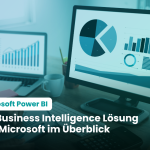 Foto: Schreibtisch mit Laptop und Bildschirm auf dem Auswertungen zu sehen sind - Microsoft Power BI einfach erklärt